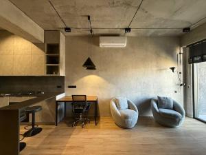 a kitchen with two chairs and a table in a room at Designer View Vake in Itʼkhvisi