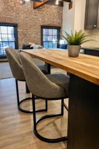 a wooden table with two chairs and a potted plant at Brick & Bed Riverfront Lofts, T 401 in Saint Louis