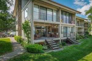 an apartment building with a balcony and a yard at Base Camp for all of Sandpoint and Lake Pend Oreille Adventures in Sandpoint