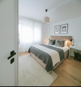a bedroom with a large bed and a window at Apartment Rea in Čapljina