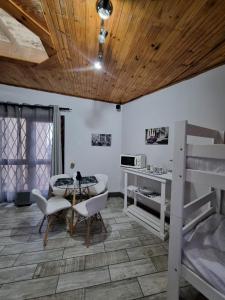 a room with a bed and a table and chairs at Seaview Serenity in Gqeberha
