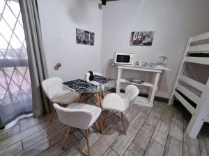 a small room with a table and chairs and a bed at Seaview Serenity in Gqeberha