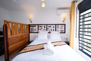 En eller flere senge i et værelse på Guyane Appart'Hôtel