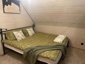a bed with two pillows and a blanket on it at Witam Karpacz 2 in Karpacz