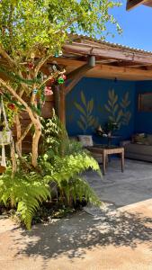 a patio with a bench and a blue wall at Mandala Camping Pousada in Florianópolis +61 photos