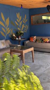 a living room with a couch and a table at Mandala Camping Pousada in Florianópolis