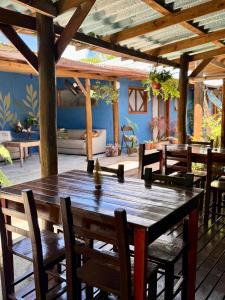 a large wooden table and chairs on a patio at Mandala Camping Pousada in Florianópolis