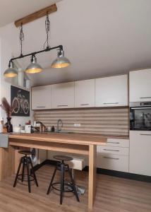 a kitchen with white cabinets and a wooden counter top at Adria in Vodice