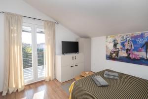 a bedroom with a bed and a flat screen tv at Adria in Vodice