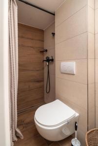 a bathroom with a white toilet and a shower at Adria in Vodice