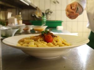 a plate of pasta on a counter in a kitchen at Ski- und Berghaus Obergmeind in Tschappina