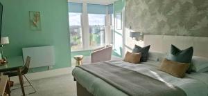 a bedroom with a large bed and a window at Hotel Penzance Harbour View in Penzance