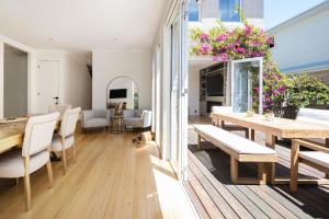a dining room and living room with a table and chairs at Evergreen by the Bay in Sandringham