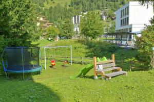 a park with a playground and a swing at Apartment Bünda in Davos +130 photos