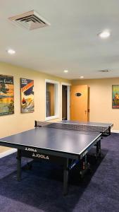 a ping pong table in the middle of a room at Waterbury Inn in Ephraim