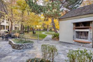 a patio with a building and a deer in the background at SureStay Plus Hotel by Best Western Reno Airport in Reno