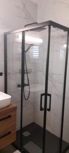 a shower with a glass door next to a sink at Apartments Luka in Korčula +49 photos