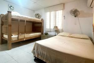 a bedroom with two bunk beds and a window at Casa campestre Magyli in Puerto Salgar +26 photos