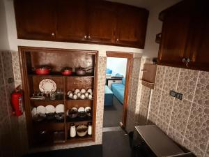 a kitchen with a cupboard filled with pots and pans at Fes Apartment 2 in Fez +44 photos