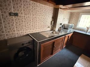 a small kitchen with a washing machine and a sink at Fes Apartment 2 in Fez