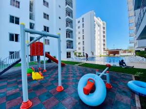 a playground in a building with a pool at Aqua Azuri apartment in Mombasa