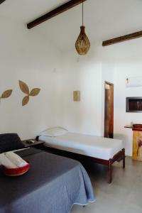 a white bedroom with a bed and a couch at Pousada Brisa Del Mar in Icaraí