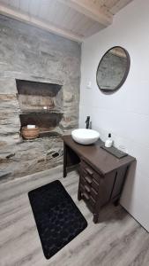 a bathroom with a sink and a mirror at Casas do Caminho in Lousã +20 photos
