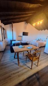 a living room with a table and a couch at Casas do Caminho in Lousã
