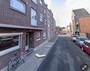 a bike parked on the side of a building at Heel Appartement 90m2 met 2 slaapkamers woonkamer Keuken badkamer privé garage in Sint-Truiden