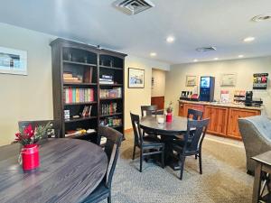 a dining room with a table and a book shelf at Waterbury Inn in Ephraim