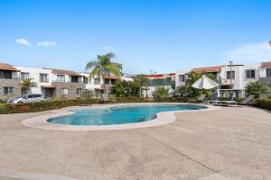 a swimming pool in the middle of a courtyard at Modern Pool Side, 3 Bdrm House with parking in Puerto Vallarta
