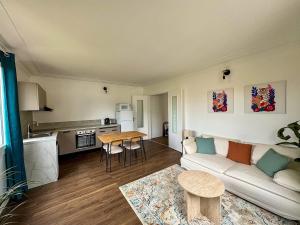 a living room with a couch and a table at Pause détente proche du Zénith & Atlantis in Saint-Herblain