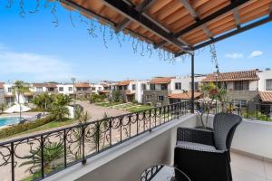 a balcony with two chairs and a view of a street at Modern Pool Side, 3 Bdrm House with parking in Puerto Vallarta