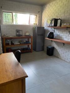 a kitchen with a refrigerator and a table in it at The Cozy Acre Unit 2 in Potchefstroom