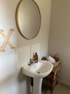 a bathroom with a sink and a mirror on the wall at The Cozy Acre Unit 2 in Potchefstroom +6 photos