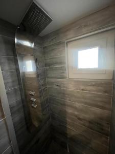 a bathroom with a shower with a window at Le Logis des Cerfs in Les Angles +40 photos
