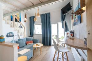 a living room with a blue couch and a table at Libera1 in Stara Baška