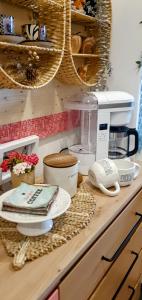 a kitchen counter with dishes and a coffee maker at Casa 1895 , Boutique Stay in a Historic Townhouse near the Beer Fountain in Žalec