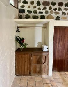 a room with a wooden cabinet with a flower on it at Jungle River Lodge in La Ceiba +106 photos