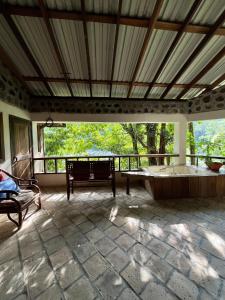 a large room with a bath tub and a balcony at Jungle River Lodge in La Ceiba