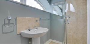 a bathroom with a sink and a shower at Snettisham Watermill Pet Friendly Historic Listed Property in Snettisham