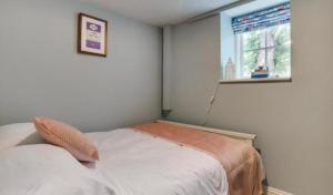 a small bedroom with a bed and a window at Snettisham Watermill Pet Friendly Historic Listed Property in Snettisham