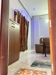 a room with a door and a chair and a table at Omshree hotel in Ujjain