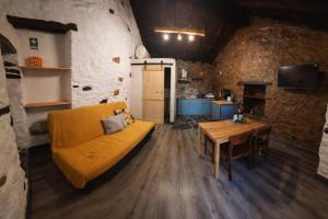 a living room with a couch and a table at Casas do Caminho in Lousã
