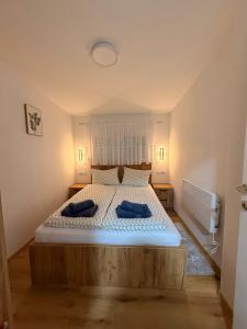 a bedroom with a bed with two pillows on it at Apartman Krznarić Centar in Županja