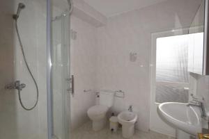 a bathroom with a shower and a toilet and a sink at Casa Panches, con Vistas al Mar in Panchés +34 photos