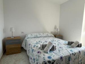 a bedroom with a bed with two pillows on it at Casa Panches, con Vistas al Mar in Panchés