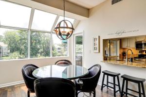 a dining room with a glass table and black chairs at Anchorage 7442 in Hilton Head Island
