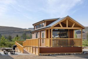 a home with a large deck and a house at Sun Outdoors Rocky Mountains in Granby