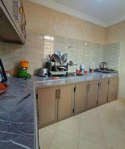 a kitchen with a sink and a counter top at AZULI ⵣ Hostel Mirleft in Mirleft